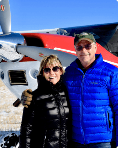 John McKenna and his wife pose by their airplane